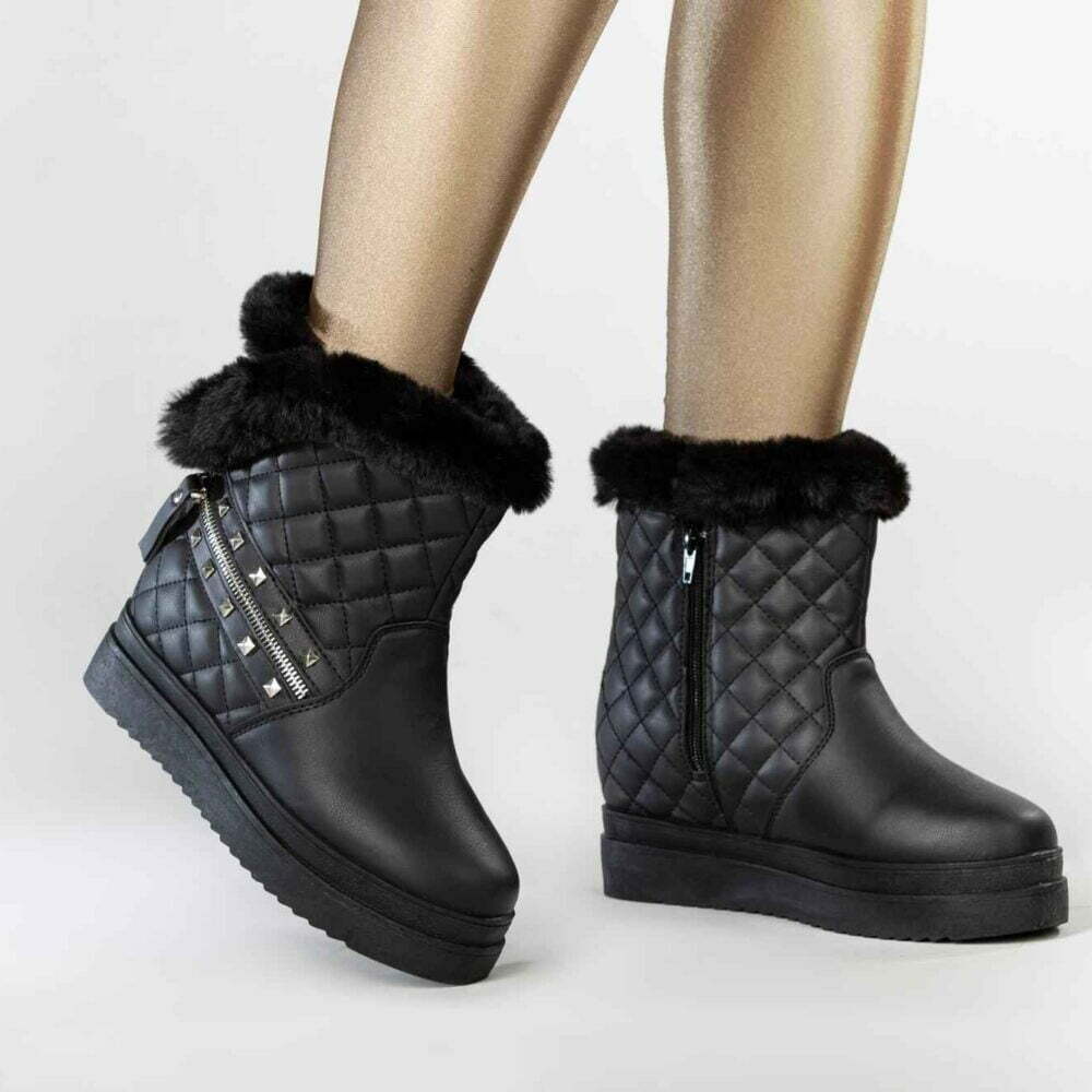 Female model wearing black winter boots