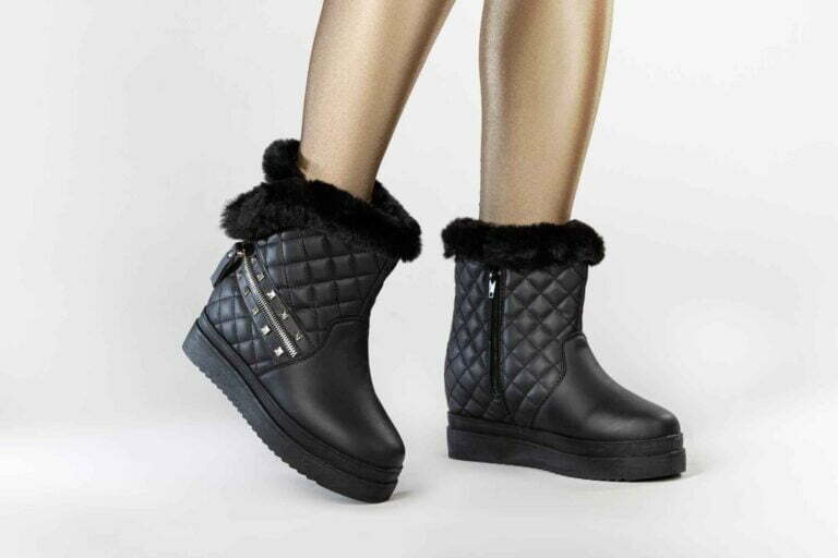 Female model wearing black winter boots