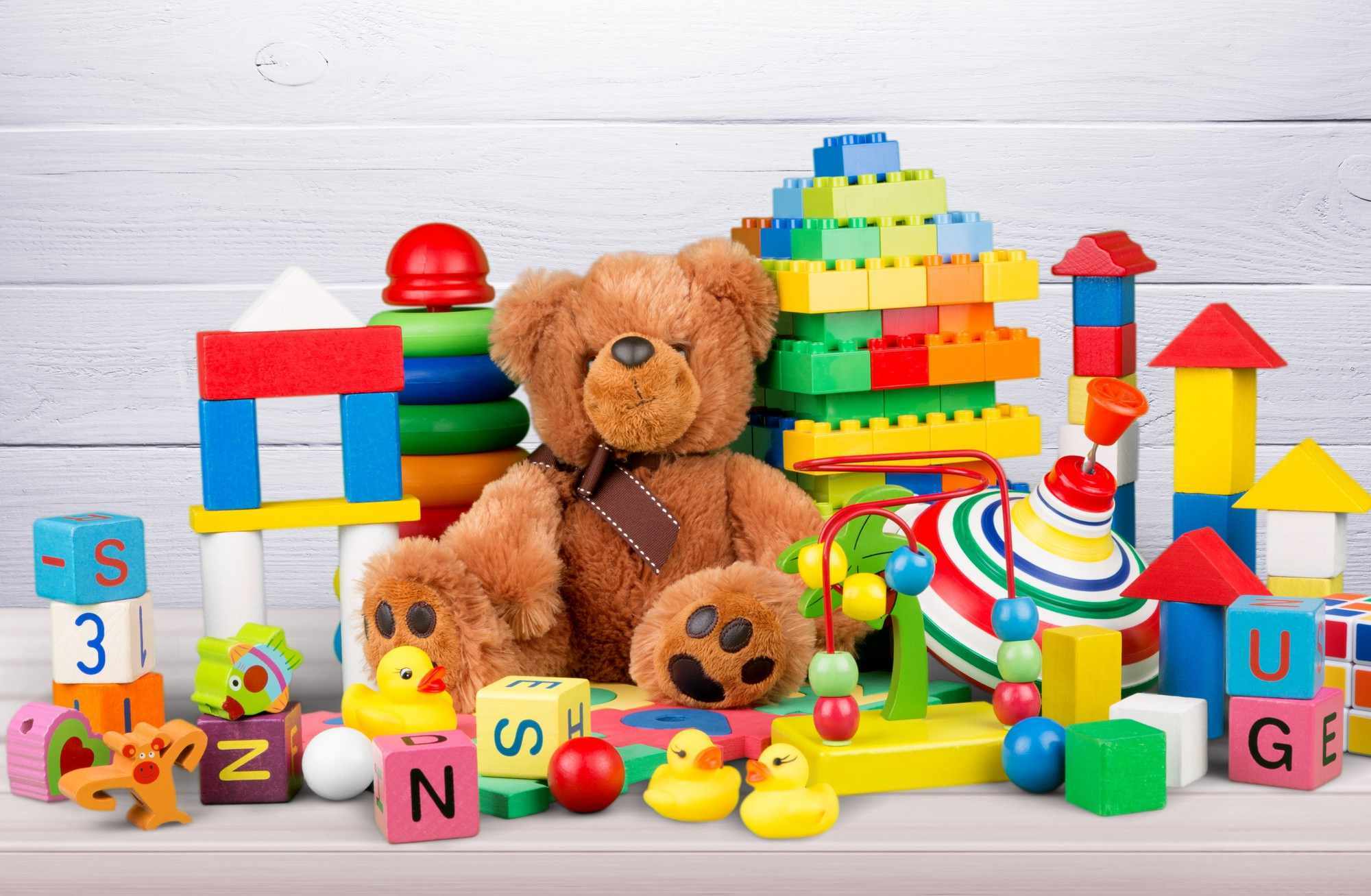 many colorful toys collection wooden desk