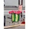 the funny pickle model socks inside the masor jar covered with red cloth lid looks like real pickle in the kitchen table
