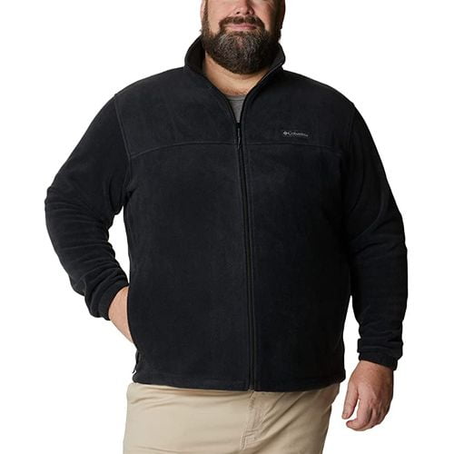 A fat man wearing full zipped fleece jacket black with cream color pant