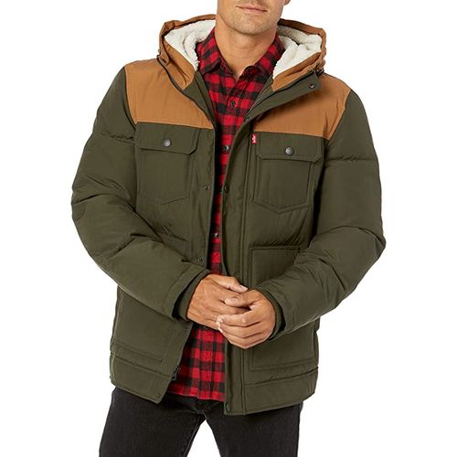 A man wearing green hooded puffer jacket on top of red plaid shirt A man wearing green hooded puffer jacket on top of red plaid shirt