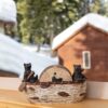 A wooden home decor featuring the Bear family rides in coaster and a daddy do the peddaling kept on the table outside the snow and tree view
