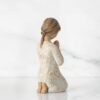 Back view of a girl hand crafted figure praying god Back view of a girl hand crafted figure praying god