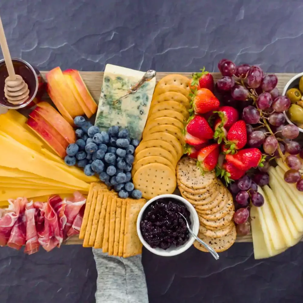 Charcuterie Board with all gourmet cheese crackers fruits and olives