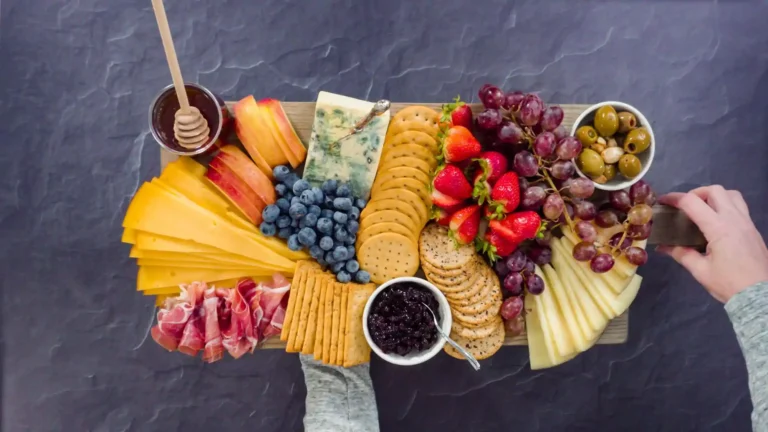 Charcuterie Board with all gourmet cheese crackers fruits and olives