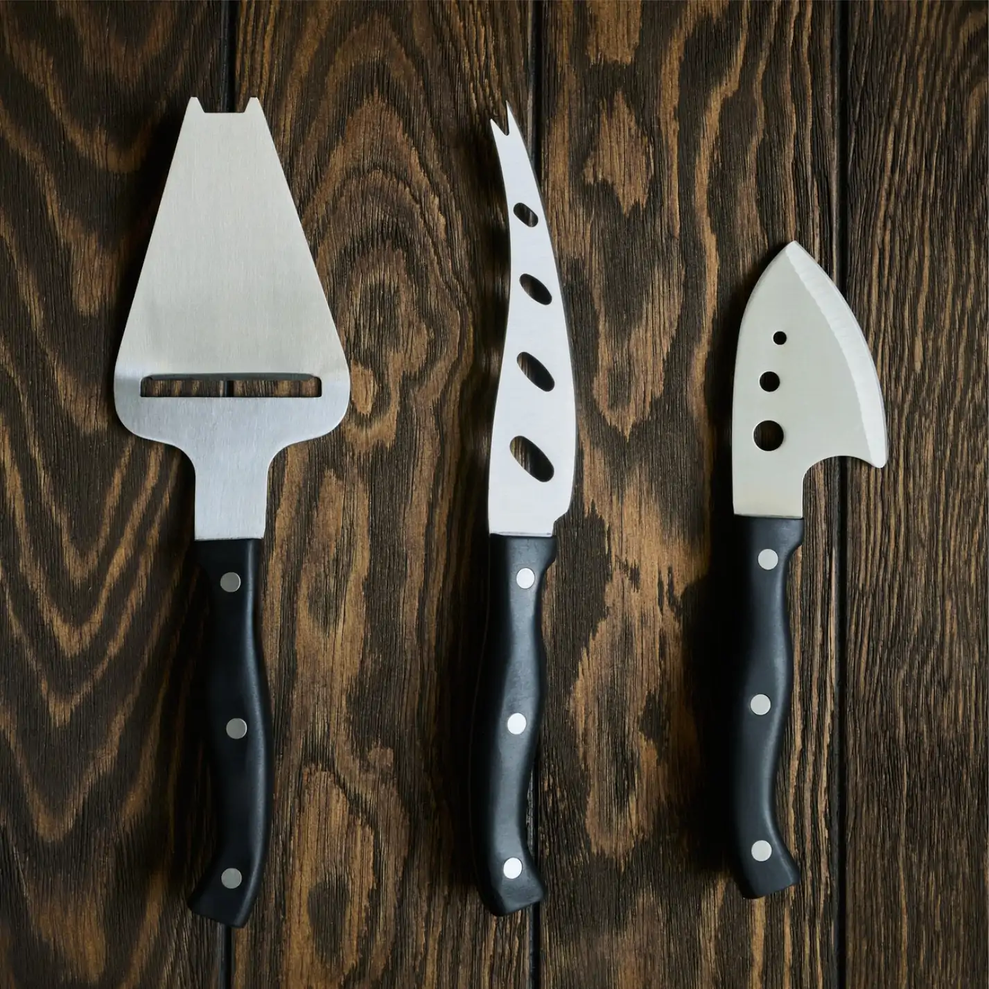 Cheese Knives laying on the wood Cheese Knives laying on the wood