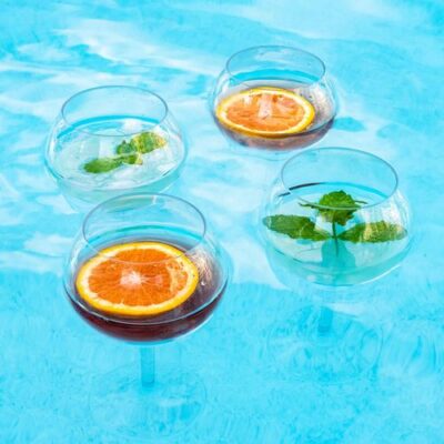 Wine glasses are floating in the swimming pool