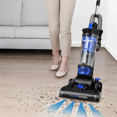 Woman cleaning the floor using eureka powerspeed vacuum cleaner Woman cleaning the floor using eureka powerspeed vacuum cleaner