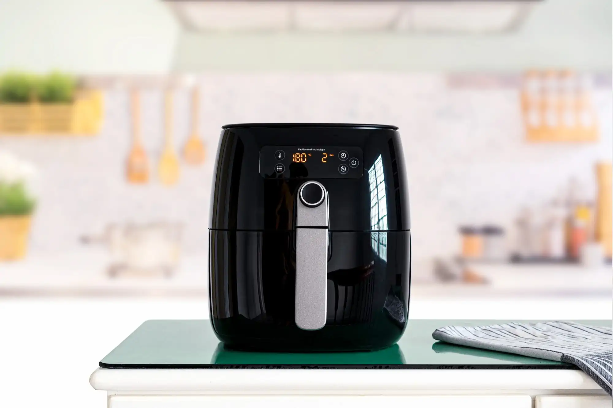 black air fryer machine cooking while placed on top of the table