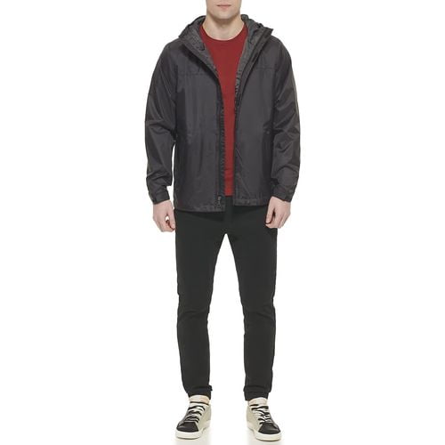 man wearing Tommy Hilfiger nylon jacket inside the red shirt and black and white shoe