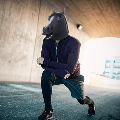 A man exercising wearing horse head face mask