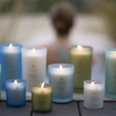 A woman doing yoga with scented candles