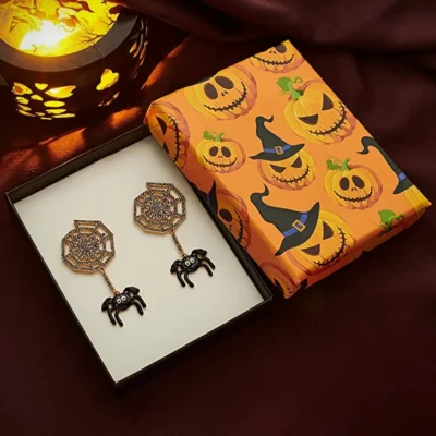 Spider Stone Earring gift wrapped with halloween themed pumpkin witch gift wrapper kept beside the night lamp 29