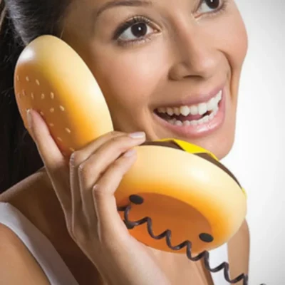 Woman speaking in the cheeseburger wired landline phone