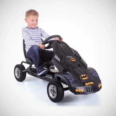 a boy playing with batman gokart 37