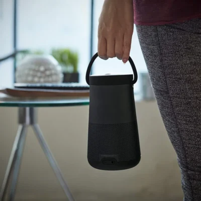 woman carrying bose speaker in her hand