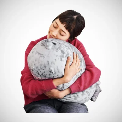 woman cuddling seal fluffy pillow woman cuddling seal fluffy pillow