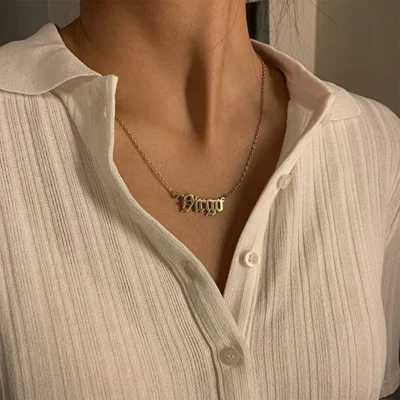 woman wearing virgo written gold necklace